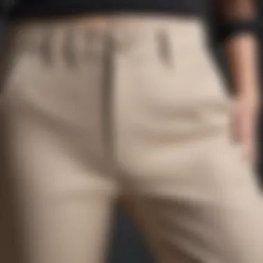 A close-up shot of the elastic waistband detailing on a pair of straight leg pants.